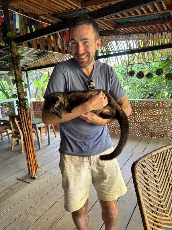 Steven Shonts, founder of The Hermit Calamari Jerky, smiling in a tropical setting