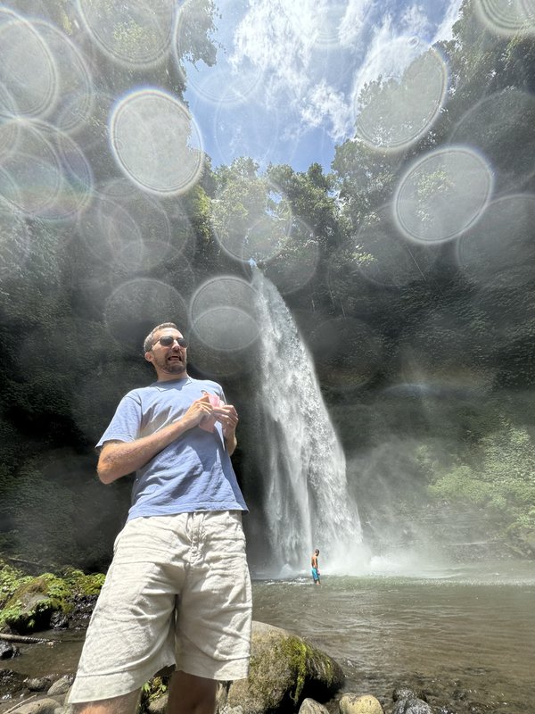 Steven Shonts exploring a waterfall in the tropics